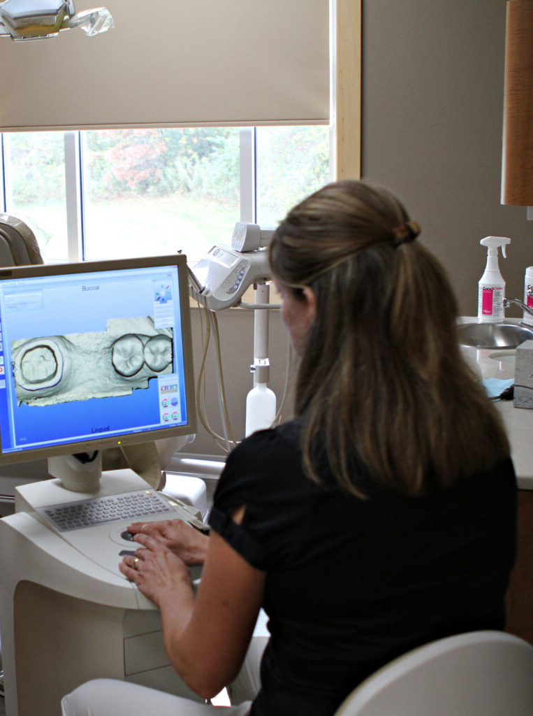 Dental technician reviews x-rays on a computer at our family dentistry practice. 